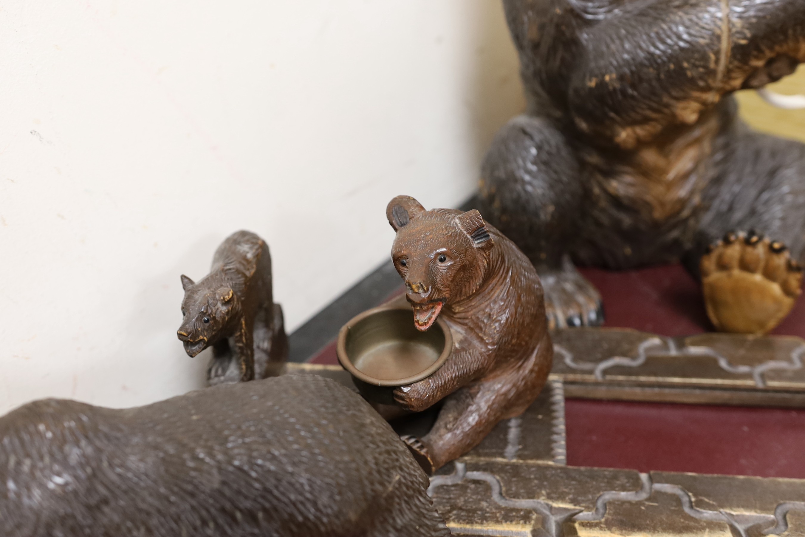 A group of Black Forest carved wood bears: a lamp, a book rack, etc.